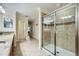 Clean bathroom featuring a glass shower, granite counters, and neutral tile flooring at 2999 Buccaneer Palm Rd, Kissimmee, FL 34747