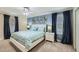 Cozy bedroom with blue accent wall, white furniture, and soft carpet flooring at 2999 Buccaneer Palm Rd, Kissimmee, FL 34747