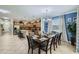 Spacious dining area flowing into modern kitchen with bar seating and stainless appliances at 2999 Buccaneer Palm Rd, Kissimmee, FL 34747
