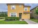 Inviting two-story home featuring a well-maintained lawn and an attached one car garage at 2999 Buccaneer Palm Rd, Kissimmee, FL 34747