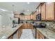 Well-lit kitchen showcasing granite counters, stainless appliances, and tile backsplash at 2999 Buccaneer Palm Rd, Kissimmee, FL 34747