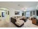 Spacious living room with plush carpeting, a ceiling fan, and comfortable seating including a large sectional sofa at 2999 Buccaneer Palm Rd, Kissimmee, FL 34747