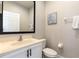 Cozy powder room with a white vanity, stylish mirror, and modern fixtures at 3069 White Orchid Rd, Kissimmee, FL 34747