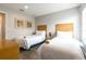 Bright bedroom featuring two twin beds, neutral walls and wood-look flooring at 3069 White Orchid Rd, Kissimmee, FL 34747