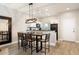 Open concept dining area boasts a kitchen view, hard wood floors, modern decor, and a stylish light fixture at 3069 White Orchid Rd, Kissimmee, FL 34747