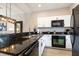 Modern kitchen featuring granite countertops, stainless steel appliances, and white cabinetry at 3069 White Orchid Rd, Kissimmee, FL 34747