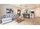Open-concept living room showcasing hardwood floors, modern decor, stylish furnishings, and a dining area at 3069 White Orchid Rd, Kissimmee, FL 34747