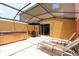 Covered patio featuring a spa, seating, and a sliding glass door at 3069 White Orchid Rd, Kissimmee, FL 34747
