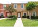 Charming townhouse exterior boasts a tile roof, lush lawn, and attractive landscaping features at 3069 White Orchid Rd, Kissimmee, FL 34747