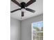 Bedroom view showcasing a ceiling fan and a window with a view of a tree and blue skies at 312 Arbor Lakes Dr, Davenport, FL 33896