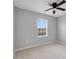 This is a bright bedroom with a ceiling fan and large window with blinds at 312 Arbor Lakes Dr, Davenport, FL 33896
