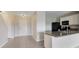Open-concept kitchen features granite countertops, stainless appliances, tile flooring, and connects to the living area at 312 Arbor Lakes Dr, Davenport, FL 33896