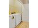 Convenient laundry area with a washer, dryer, and shelving for storage at 312 Arbor Lakes Dr, Davenport, FL 33896