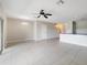 Bright, open living room with neutral paint, tile flooring, and a ceiling fan providing ample natural light at 312 Arbor Lakes Dr, Davenport, FL 33896