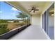 Screened-in patio featuring a ceiling fan and a view of the lake, sky, and trees at 312 Arbor Lakes Dr, Davenport, FL 33896