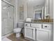 Bright bathroom with vanity, granite counters, glass door shower, and recessed lighting at 3193 Yellow Lantana Ln, Kissimmee, FL 34747