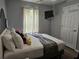 Comfortable bedroom with a Mickey Mouse theme, featuring a bed, TV, and natural light at 3193 Yellow Lantana Ln, Kissimmee, FL 34747