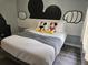 Up close shot of a neatly made bed with Mickey Mouse plushies at 3193 Yellow Lantana Ln, Kissimmee, FL 34747