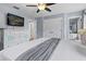 Serene bedroom with a dresser, television, view into the bathroom, and ample closet space at 3193 Yellow Lantana Ln, Kissimmee, FL 34747