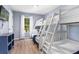 Cozy bedroom with triple bunk beds, blue walls, wood floor and a window for natural light at 3193 Yellow Lantana Ln, Kissimmee, FL 34747