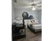 Inviting bedroom featuring modern ceiling fan, wood floors, Mickey Mouse decor and neutral colors at 3193 Yellow Lantana Ln, Kissimmee, FL 34747