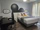 Playful bedroom with grey walls, wood floors, Mickey Mouse accents, and a comfortable bed at 3193 Yellow Lantana Ln, Kissimmee, FL 34747