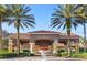 View of the building entrance framed by palm trees and lush greenery at 3193 Yellow Lantana Ln, Kissimmee, FL 34747