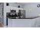 Kitchen featuring white cabinets, stainless steel appliances, and a breakfast bar with seating at 3193 Yellow Lantana Ln, Kissimmee, FL 34747