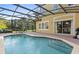 Backyard pool with a screened lanai, patio furniture, and clear blue water at 3193 Yellow Lantana Ln, Kissimmee, FL 34747
