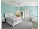 Spacious bedroom with neutral tones, ceiling fan, and ensuite bathroom access at 3198 Abana Path, The Villages, FL 32163