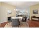 Elegant dining room with a marble table and chairs, hardwood floors, and neutral color scheme at 3198 Abana Path, The Villages, FL 32163