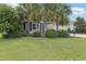 Attractive single-story home with a lush green lawn and mature landscaping at 3198 Abana Path, The Villages, FL 32163