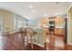 Bright kitchen boasts stainless steel appliances, tile backsplash, and breakfast bar with seating at 3198 Abana Path, The Villages, FL 32163
