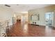 Open living space with hardwood floors, entertainment center, and views to the dining and bedroom areas at 3198 Abana Path, The Villages, FL 32163