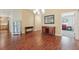 Dining room with hardwood floors, leading to other rooms in an open concept living space at 3198 Abana Path, The Villages, FL 32163