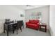 Dedicated office space features a large desk, a comfortable couch, and bright natural light at 3198 Abana Path, The Villages, FL 32163