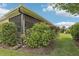 The screen room is surrounded by bushes and trees, and there is a yard on the side of the house at 3198 Abana Path, The Villages, FL 32163