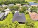 Aerial view of a home with lush backyard, situated in a neighborhood and pond nearby at 3380 Pawleys N Loop, St Cloud, FL 34769