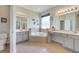 Bright bathroom with a soaking tub, dual vanities, and tile flooring at 3380 Pawleys N Loop, St Cloud, FL 34769