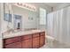 Bathroom features a vanity with wood cabinets, a large mirror, and a shower with a white curtain at 3380 Pawleys N Loop, St Cloud, FL 34769