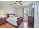 Comfortable bedroom with hardwood floors, ceiling fan, and a bright window providing natural light at 3380 Pawleys N Loop, St Cloud, FL 34769