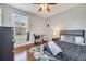 Cozy bedroom features wood floors, a ceiling fan, and a desk area at 3380 Pawleys N Loop, St Cloud, FL 34769