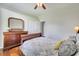 Inviting bedroom features wood flooring, ceiling fan, ample natural light, and neutral decor at 3380 Pawleys N Loop, St Cloud, FL 34769
