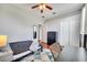This bedroom features wood floors, a ceiling fan, closet and adjacent bathroom entrance at 3380 Pawleys N Loop, St Cloud, FL 34769