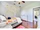 Cozy bedroom with unique wall decoration, stylish furnishings, wood flooring, and ample closet space at 3380 Pawleys N Loop, St Cloud, FL 34769