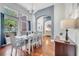 Bright dining room boasts hardwood floors, chandelier, and large windows with a view at 3380 Pawleys N Loop, St Cloud, FL 34769
