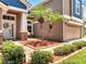 Charming home exterior featuring a landscaped yard, and cozy front porch sitting area at 3380 Pawleys N Loop, St Cloud, FL 34769