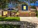 Charming two-story home with a three-car garage and manicured front lawn at 3380 Pawleys N Loop, St Cloud, FL 34769