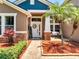Charming home exterior with a brick pathway, palm trees, and a welcoming front porch at 3380 Pawleys N Loop, St Cloud, FL 34769