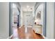 Elegant hallway with arched doorways, hardwood floors, and stylish console table at 3380 Pawleys N Loop, St Cloud, FL 34769